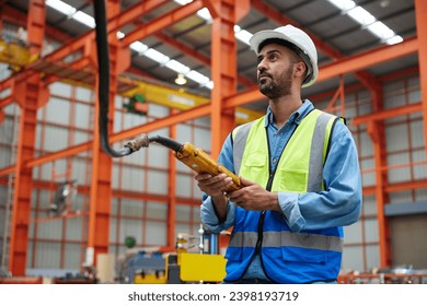 worker or engineer operating remote switch to control machine in the factory