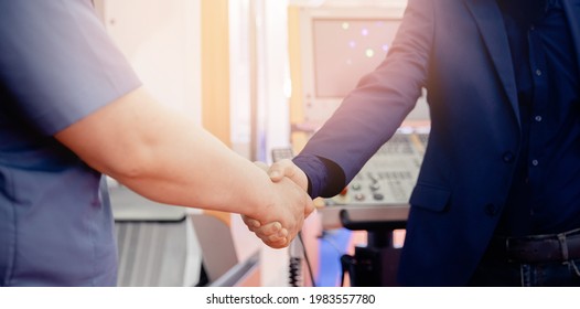 Worker engineer shaking hands with businessman at construction site background cnc control panel. - Powered by Shutterstock