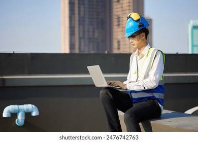 worker or engineer working on laptop computer at construction site - Powered by Shutterstock