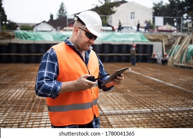 Worker, engineer,communicates with the headquarters on the construction site