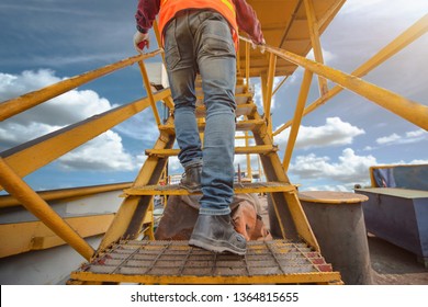 Worker, Engineering Wearing Safety Shoe With Set Of Safety And Security Regulation, Walking In Mind Step On The Steel Gangway Bridge At Workplace, Working In High Stage & Level Of Insurance