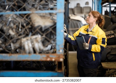 Worker examines metallic scrap inside a factory