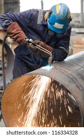 Worker In Factory Cutting Steel Pipe Using Metal Torch