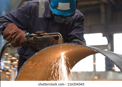 Worker In Factory Cutting Steel Pipe Using Metal Torch