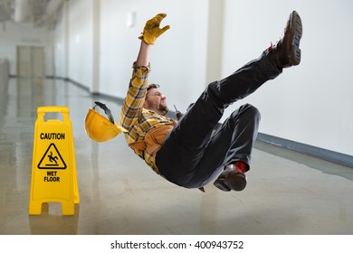 Worker falling on wet floor inside building