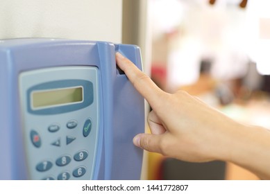 Worker Finger On Clock In Control Device In A Office. Overtime Work And Time Report Concept For Family Reconciliation In A Family Friendly Business.