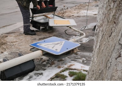 Worker Fix The Lights Of A Broken Traffic Light With Road Sign At Pole. Strong Wind