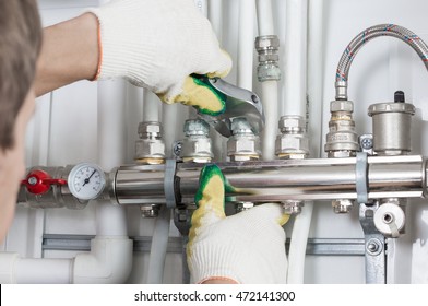 Worker fixing heating system, close up photo