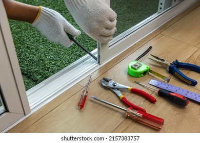 Worker Fixing The Insect Screen Sliding Door