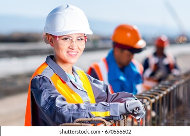 Worker Fixing Steel Rebar At Building Site