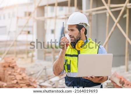 worker foreman engineer builder working using radio command in home construction site safety check. Foto stock © 