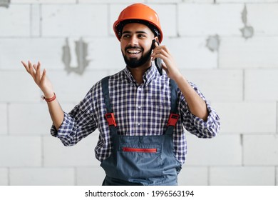 Worker In Front Of Construction Site Talking On Smart Phone