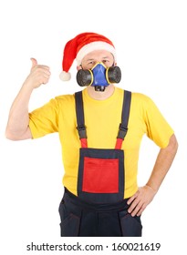 Worker in gas mask and santa hat shows thumb. Isolated on a white background.