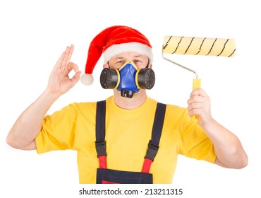 Worker in gas mask and santa hat with roller. Isolated on a white background.