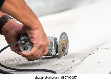 Worker Grind Hard Floor. Worker With High Shear Grinder Cut And Mill Cement Or Asphalt Or Concrete To Separate Surface Of Floor Away. Danger Job.