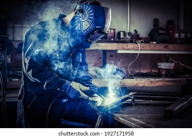 worker grinding a metal plate