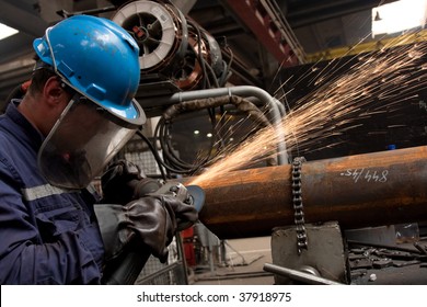 Worker Grinding Metal And Sparks