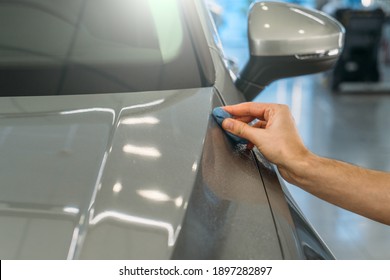 Worker Hand Clean Car Body With Blue Clay For Cleaning Before Applying Protective Layer Or Coating To Auto. Car Detailing Concept