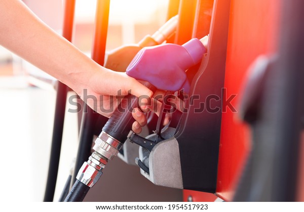 Worker hand at Gas station
handle fuel nozzle at fuel dispensers for filling car engine
gasoline 