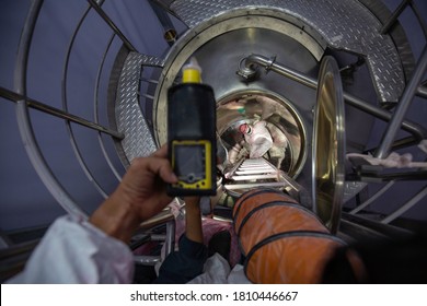 Worker Hand Holding Gas Detector Inspection Safety Gas Testing At Front Manhole Stainless Shiny Tank Male Worker Inside Confined Space