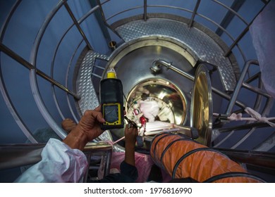 Worker Hand Holding Gas Detector Inspection Safety Gas Testing At Front Manhole Stainless Shiny Tank Male Worker Inside Confined Space