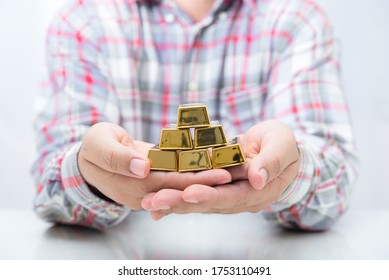 Worker Hand Holding Stack Of Gold Bar , Saving Concept