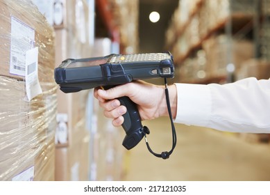 worker hand man scanning package with warehouse barcode scanner in modern storehouse