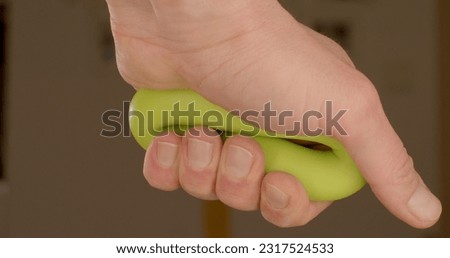 IT worker hand training. Squeezing and squeezing the rubber ring with your fingers. Activation of the blood circulation of the limb. Active arm muscle training after using the computer. 