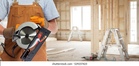worker hands with electric saw