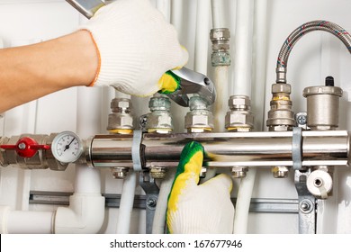 Worker hands fixing heating system