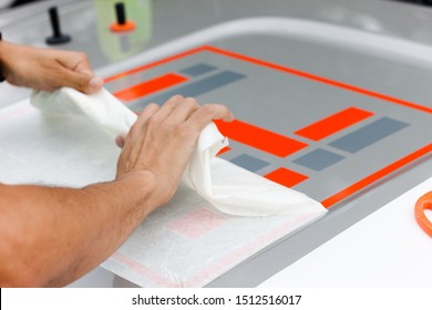 Worker Hands Installing Graphic Designs