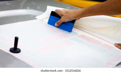 Worker Hands Installing Graphic Designs