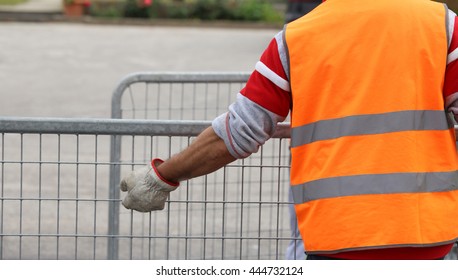 Worker With High Visibility Reflective Jacket And Gloves Moves Many Hurdles