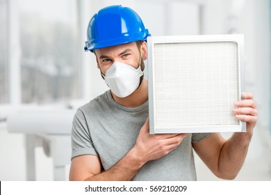 Worker Holding Air Filter For Installing In The House Ventilation System. Purity Of The Air Concept