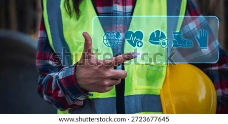 Worker holding hard hat with EHS and safety management digital for industrial workplace protection and occupational health compliance, health and safety, quality management,