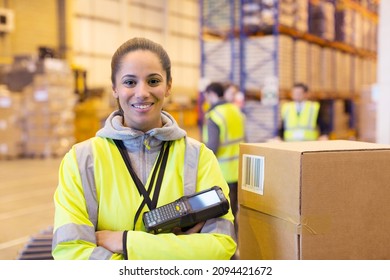 Worker holding scanner in warehouse
