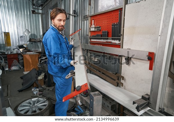 Worker holding\
special tool for auto\
repair