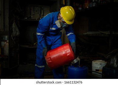 A Worker Industry Wearing Safety Uniform ,black Gloves And Gas Mask Under Checking Chemical Tank In Industry Factory Work