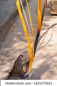 Worker Inserts Fiber Optic Cables Buried In A Micro Trench