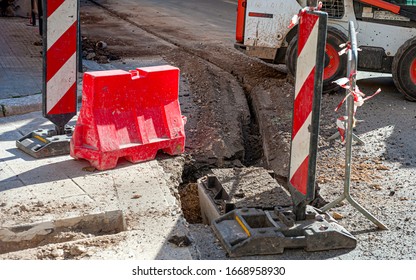 Worker Inserts Fiber Optic Cables Buried In A Micro Trench