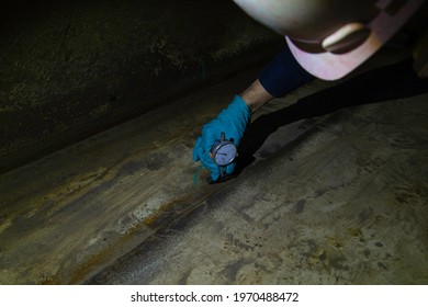 Worker Inspect Floor Thickness Of The Chemical Storage Tank With A Tool.