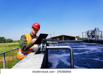 Worker Inspecting Valve For Filtering Water. Focus On Valve.