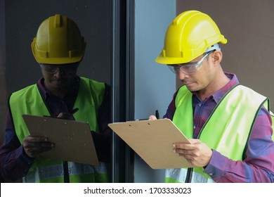 Worker, Inspector, Engineer Or Auditor Is Checking Building Structure Around Window With Checklist Clipboard In Hand. Inspection, Quality Checking And Audit Concept