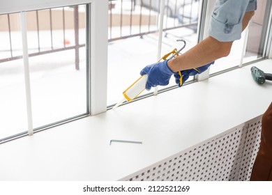 The worker installing and checking window in the house