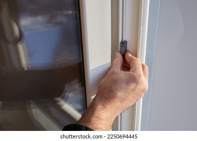 The worker installing and checking window in the house - Shutterstock ID 2250694445