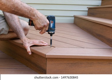 Worker Installing Composite Wood Decking - Shutterstock ID 1497630845