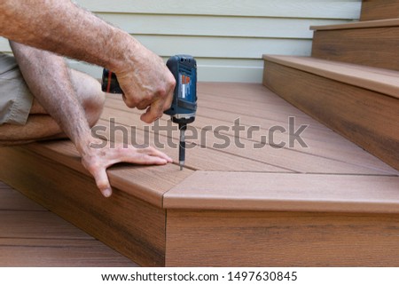 Worker Installing Composite Wood Decking