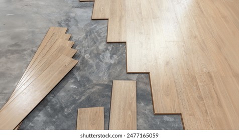 Worker Installing Interlocking laminate floor, home renovation.