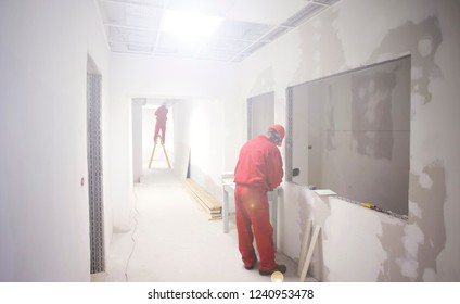 worker are installing plasterboard for gypsum walls in apartment under construction, remodeling, renovation, restoration, extention and reconstruction - Shutterstock ID 1240953478