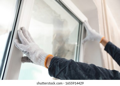 Worker installing plastic window indoors, closeup view - Shutterstock ID 1655914429